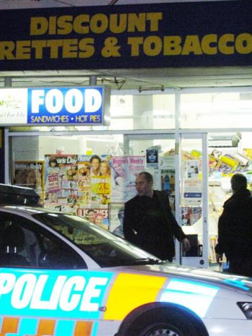 Police make inquiries at the Melbourne Dairy in South Dunedin after it was on Saturday night....