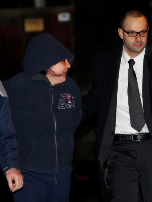 Police Officers escort Erika Menendez to an awaiting car in the Queens borough of New York....