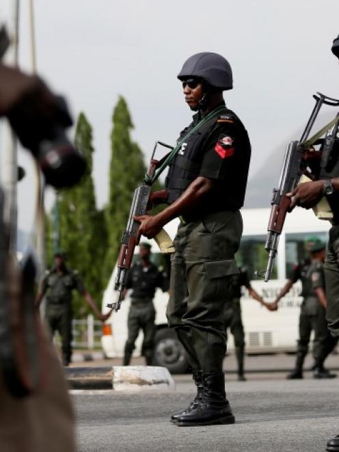 Police officers patrol during a recent protest by the Abuja wing of the 'Bring Back Our Girls'...