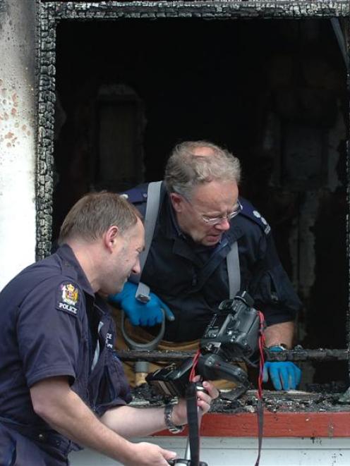 Police photographer Craig McKersey and Southern Region safety fire officer Barry Gibson inspect...