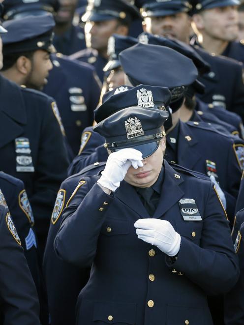 Policemen line-up near the Christ Tabernacle Church ahead of the funeral services of New York...