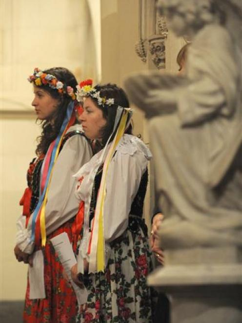 Polish community members Natasha Nawrocki (left) and Sarah Hight attend the Mass last night....