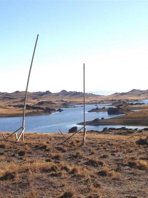 Poolburn Dam with poles showing the profile of one of two houses proposed to be built on the...