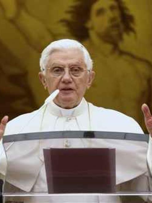 Pope Benedict XVI delivers his Angelus prayer from his window overlooking the courtyard of his...