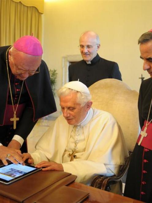Pope Benedict XVI uses an iPad at the Vatican in this file photo. REUTERS/Osservatore Romano
