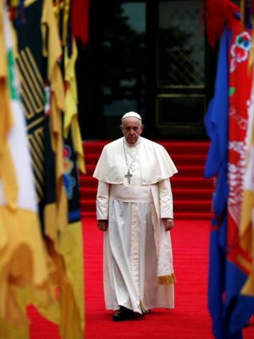 Pope Francis arrives to attend a welcoming ceremony at the presidential Blue House in Seoul....
