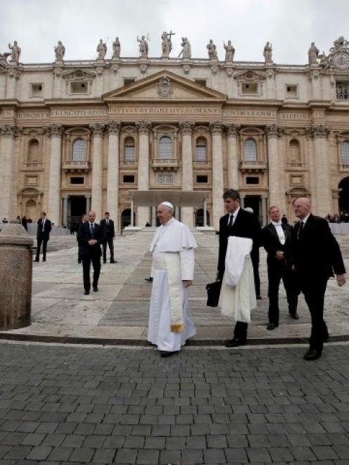 Pope Francis (C) leaves at the end of the general audience in St. Peter's Square at the Vatican....