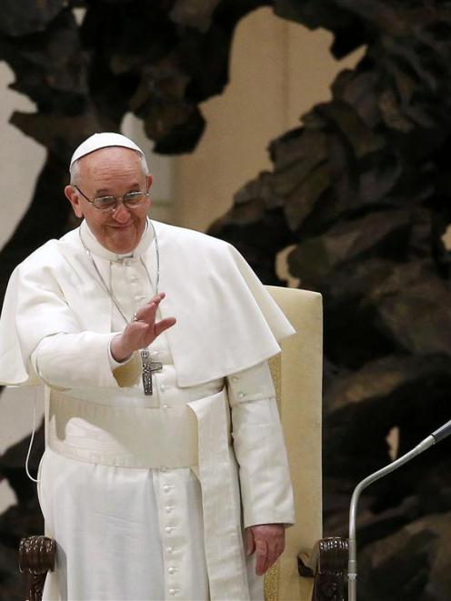 Pope Francis I waves during an audience for members of the media in the Paul VI hall at the...