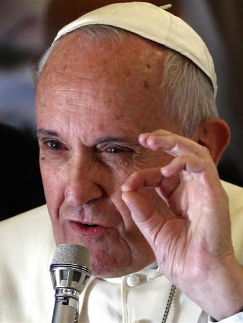 Pope Francis makes a point as he speaks to journalists on his flight back from Manila to Rome on...