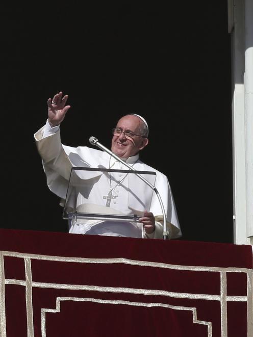Pope Francis waves during his Sunday Angelus prayer in Saint Peter's Square at the Vatican. Pope...