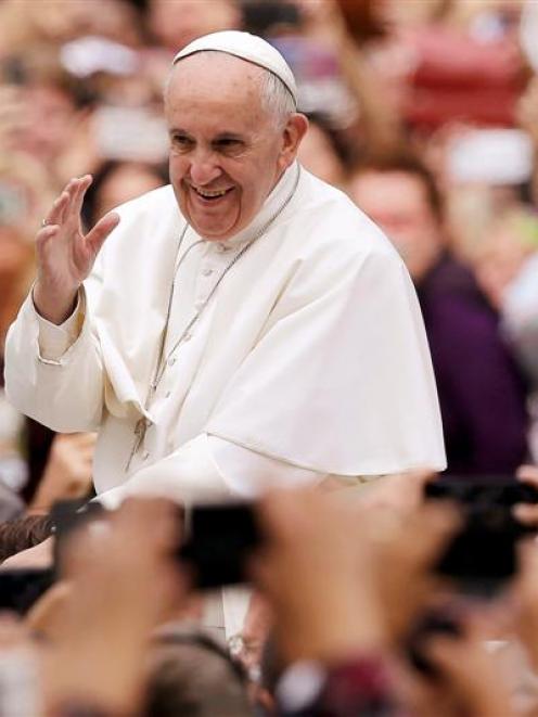 Pope Francis waves from the popemobile during a parade in Philadelphia. Photo: Reuters