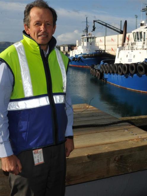 Port Otago's Geoff Plunket in front of the Ports tug Otago. Photo by ODT.