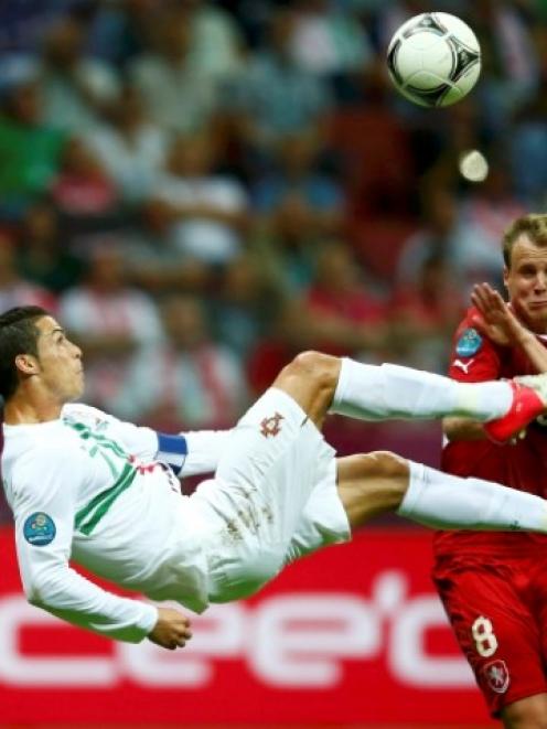 Portugal's Cristiano Ronaldo kicks the ball in front of Czech Republic's Michal Kadlec (R) during...