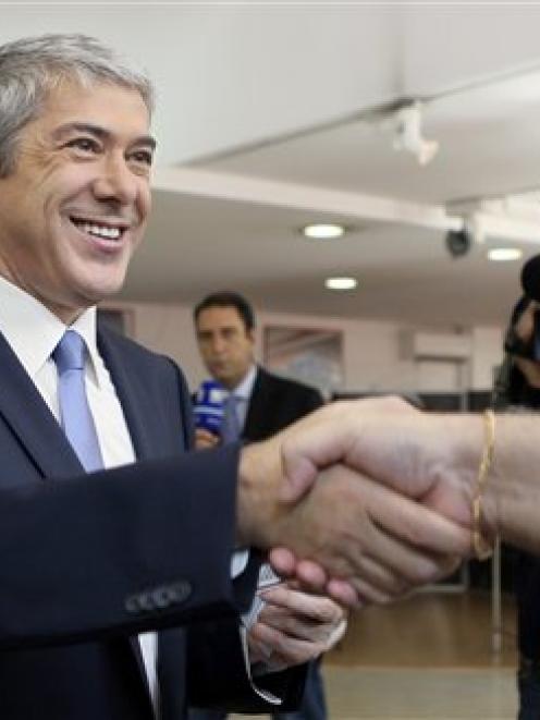 Portuguese Prime Minister and Socialist Party leader Jose Socrates shakes hands with electoral...