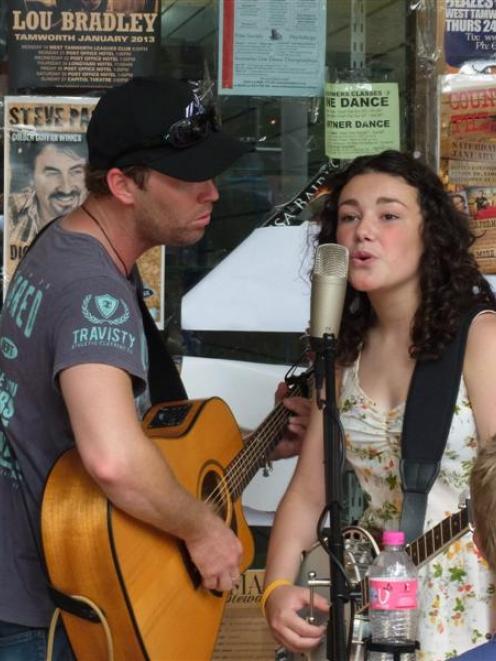 Postal band member Jason Grice,  of Sydney, and Gore's Jenny Mitchell (13) busk at the Tamworth...