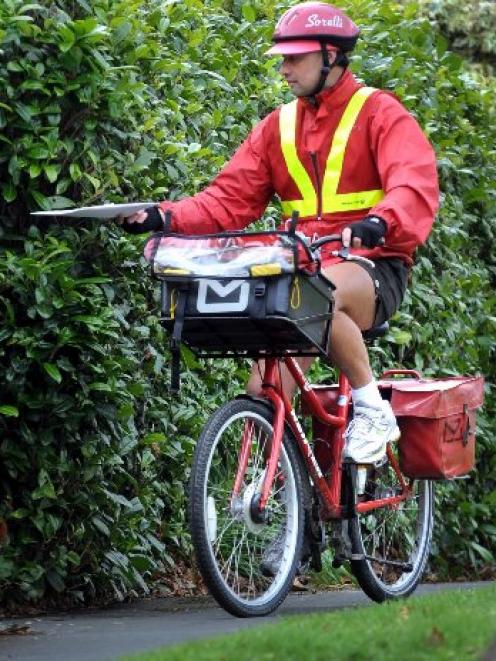 Postie Kerry Wheeler delivers mail in Northeast Valley.  Photo by Peter McIntosh.