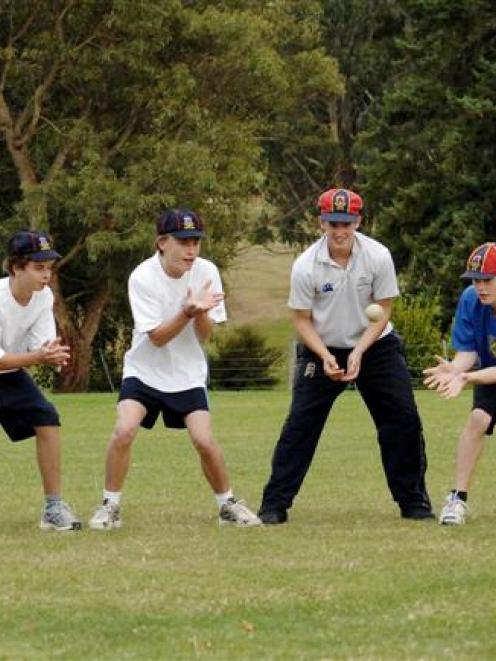 Practising slip catches with sports co-ordinator Michael MacKenzie (right) are John McGlashan...