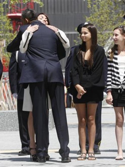 President Barack Obama hugs Diane Wall, wife of Glen James Wall who died at the World Trade...