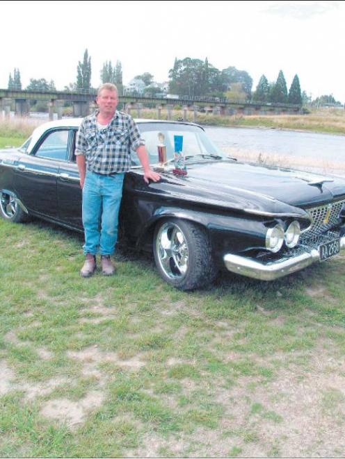 Pride and joy: Michael Hood stands beside his late father ’ s 1961 P lymouth B elvedere , which...