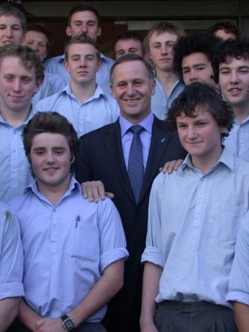 Prime Minister John Key poses with senior pupils from Waitaki Boys' High School during his visit...