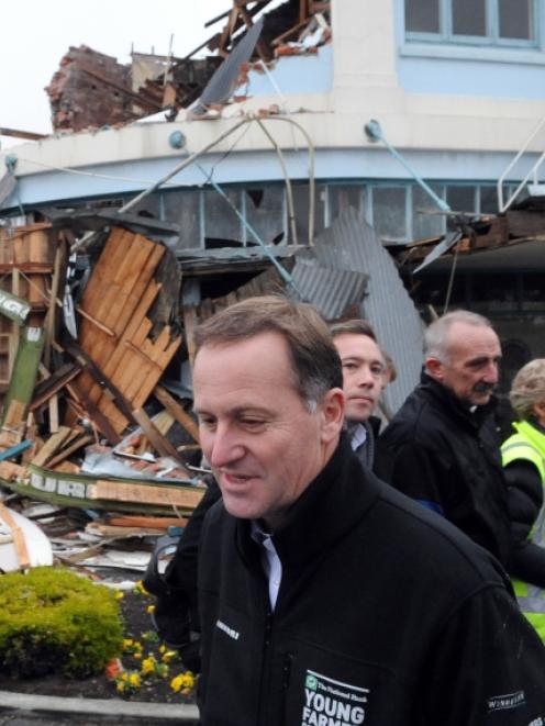 Prime Minister John Key surveys earthquake damage to Blackwells Department Store in Kaiapoi,...