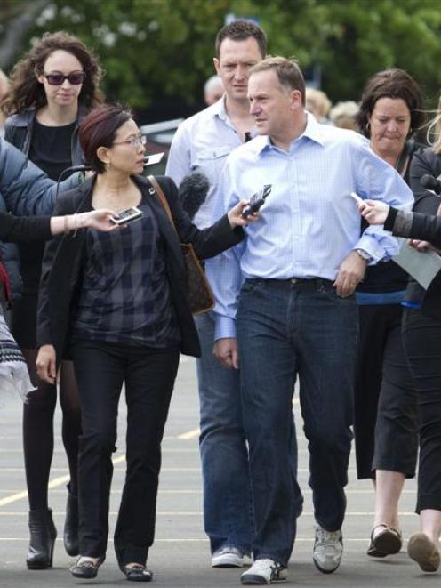 Prime Minister John Key talks to the media in Auckland on his way to vote in Saturday's general...