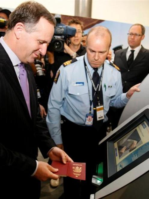 Prime Minister John Key tries out the new technology "Smartgate" for people travelling between...