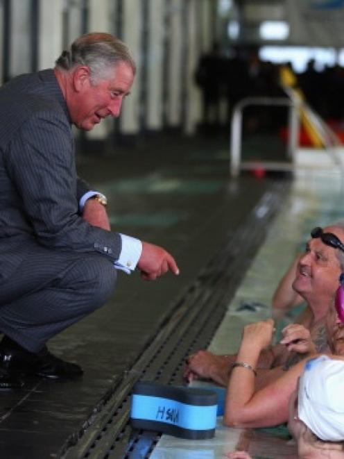 Prince Charles chats with swimmers at the Millenium Sports Institute. (Photo by Phil Walter/Getty...