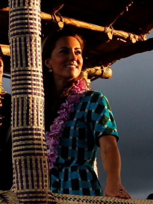 Prince William and Catherine, the Duchess of Cambridge, board a decorated truck at Honiara...