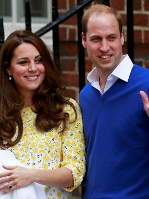 Prince William and his wife Catherine, Duchess of Cambridge, appear with their baby daughter...