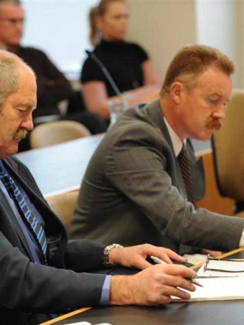 Private investigators Peter Gibbons (left) and Graeme Scott take notes during the hearing of...