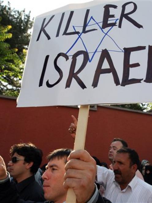 Pro-Palestinian Turks shout slogans "death to Israel" as they protest against Israel, at the...