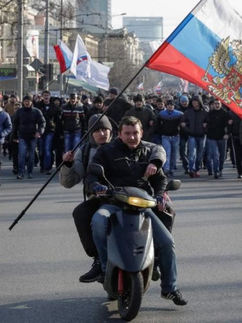 Pro-Russian demonstrators ride on a motorcycle as they take part in a rally in Donetsk, Ukraine....
