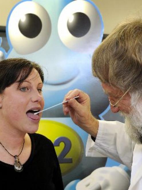 Prof John Tagg swabs from mother-to-be Anna Wescombe as part of a study on the transferral of...