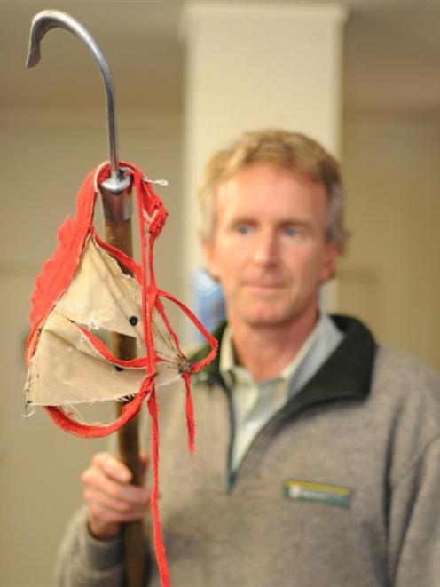 Profile ... Department of Conservation marine ranger Jim Fyfe with the item he removed from a...