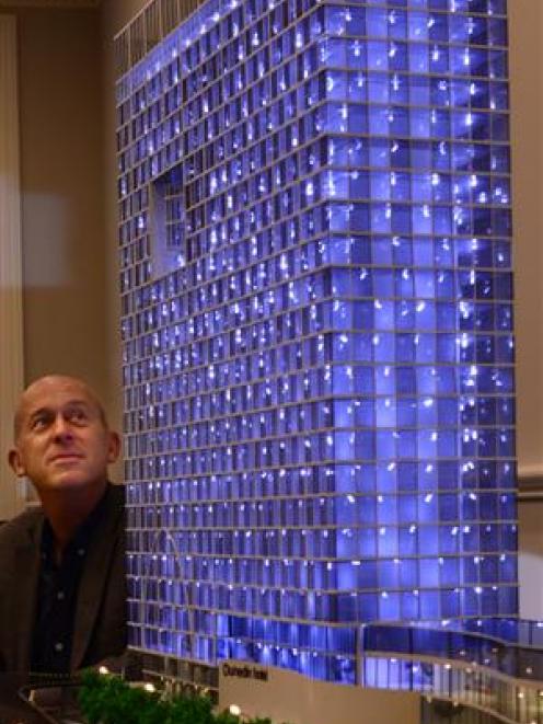 Project spokesman Steve Rodgers examines a scale model of a proposed new hotel for Dunedin, which...