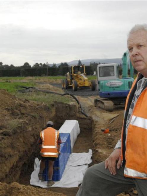 Property developer Dennis Brown (right) explains how new aqua cell rain water units will remove...