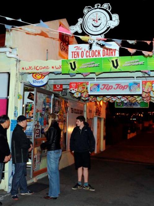 Proprietors of the 10 O'Clock Dairy (from left) Vhiyou Song and Ge Song speak to police about an...