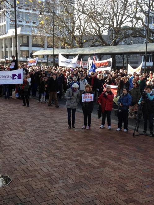 Protesters gather in the Octagon to listen to speeches. Photo by Craig Baxter