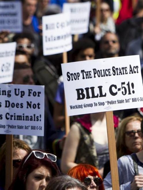 Protesters hold signs during a demonstration last month in Vancouver against Bill C-51, the...
