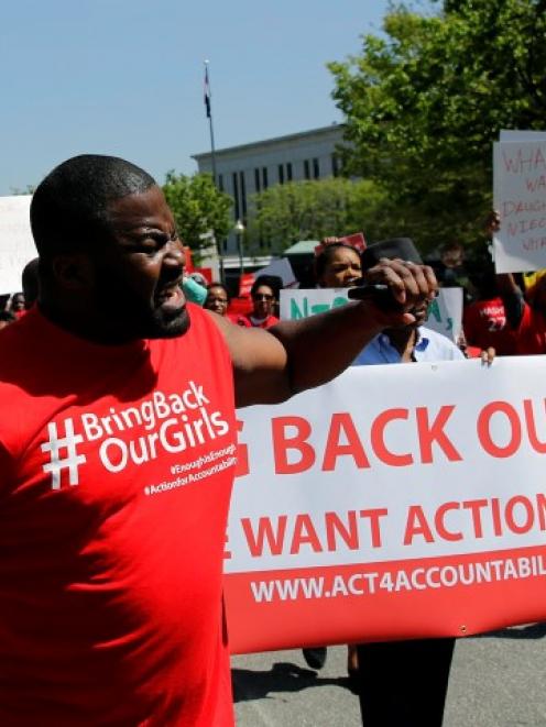 Protesters march in in front of the Nigerian Embassy in Washington in support of the girls...