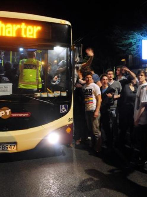 Punters wait outside the Gardens Tavern on Castle St in Dunedin for a bus into town on Friday...