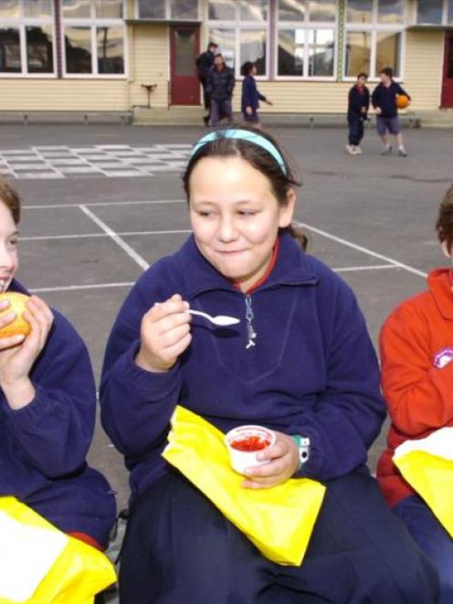 Pupils (from left) Brayden Marsh (7), Tori Bambery (10) and Kyran Marsh (5) tuck into their...