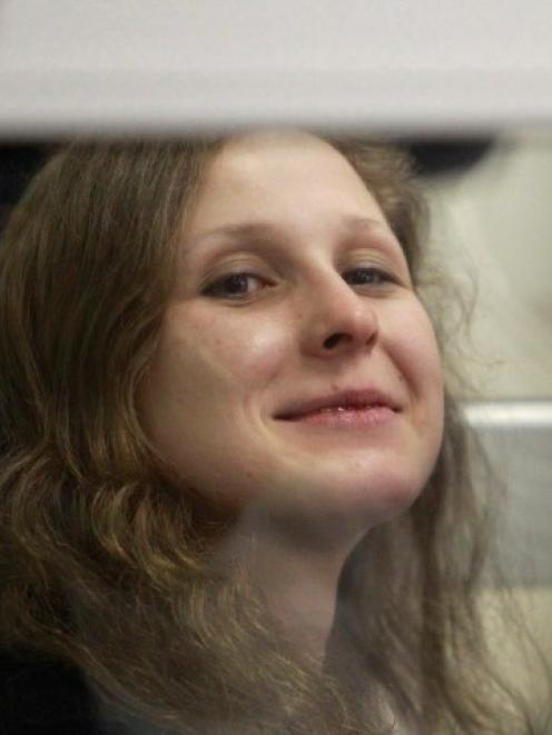 Pussy Riot member Maria Alyokhina looks out from a defendants' box during a court hearing in...