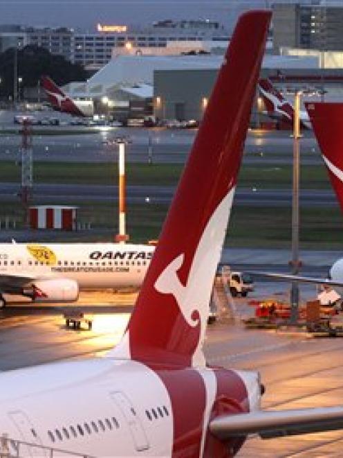 Qantas jets sit on the tarmac at the international airport in Sydney, Australia. (AP Photo/Rob...