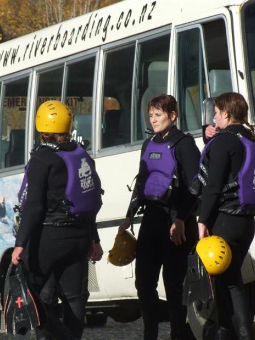 Survivors of yesterday’s ill-fated Mad Dog River Boarding trip gather beside the company minibus....