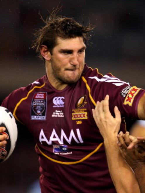 Queensland's David Taylor tries to fend off a New South Wales tackle rin game one of the State of...