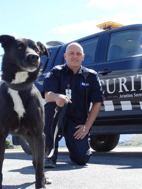 Queenstown Airport explosive detector dog Bruce, a collie-huntaway cross, with his handler Bryn...