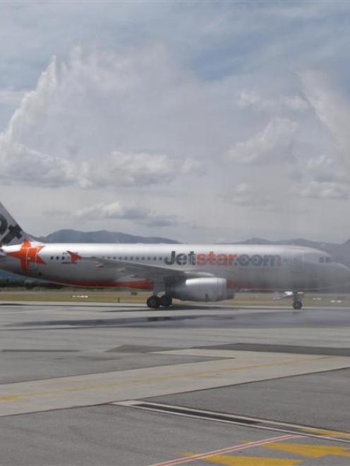 Queenstown Airport rescue tenders welcome its first Jetstar International flight yesterday, ...