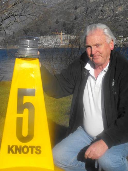 Queenstown Lakes district harbourmaster Marty Black with a safety beacon and buoy identical to...